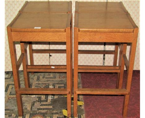 A set of four medium to light oak arts and crafts style stools, with square seats raised on rectangular cut and moulded suppo