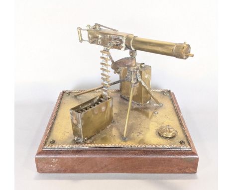 Trench Art&nbsp; Interest - military interest: a detailed brass model of a machine gun, with magazine shells, etc, set on a t