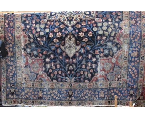 Old Persian Keshan type carpet with central floral medallion upon a navy blue ground, 340 x 240 cm (AF) 