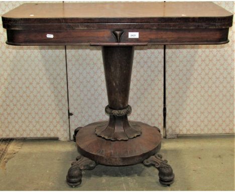 A 19th century rosewood veneered foldover top card table of rectangular form with rounded front corners raised on a central s