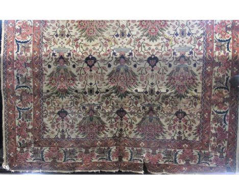 Good large Persian carpet decorated with various still life's and scrolled foliage upon a fawn ground, 310 x 220 cm 