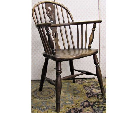 A Georgian period comb back Windsor elbow chair, principally in elm and ash, with pierced splat 