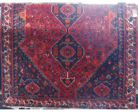 Good quality full pile Afghan runner/carpet with various medallions and still life's upon a red ground 300 x 200 cm 