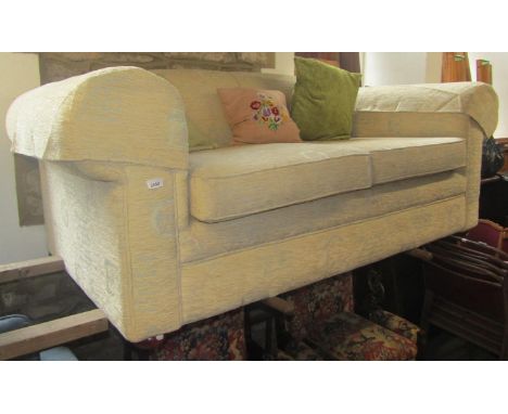 A traditional two seat sofa with scrolled arms and well upholstered finish, 180 cm wide 