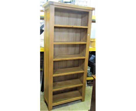 A contemporary light oak freestanding open shelving unit/bookcase with fixed shelves and panelled sides, 184 cm high x 85 cm 