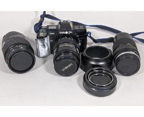 A Minolta 7000 camera, serial number 13004640 with additional lenses, travelling case, literature 