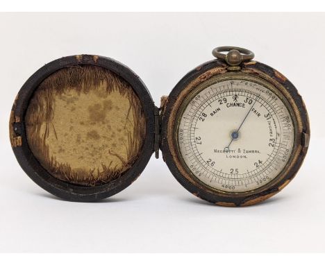A Negretti and Zambra pocket barometer in metal case diameter 4.5 cm, in fitted leather case 