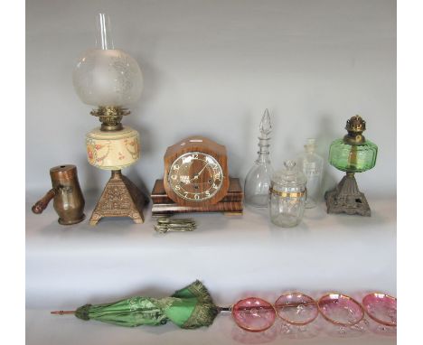 A late Victorian oil lamp with ironwork base, ceramic font and etched glass globe and one another, a ring necked decanter, pa