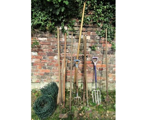 A small quantity of long handled gardening tools, together with two rolls of coated garden edging 
