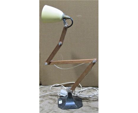 An industrial style articulated wooden desk/bench lamp with conical shade and swept cast metal base 