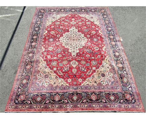 Good quality large Kashan carpet with typical floral pattern with blue running borders upon a red ground, 360 x 280 cm 