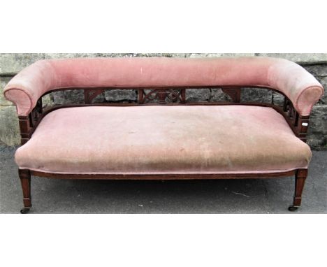 An Edwardian parlour/drawing room low two seat sofa with upholstered seat and curved back rail, with pierced fretwork panels 