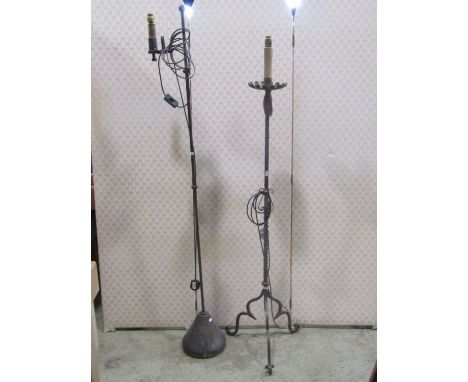 An old English style ironwork standard lamp together with one other in the gothic manner (2) 