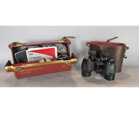 The Bolex Zoom Reflect P1 cinema camera in leather case and a pair of 9 x 35 vintage binoculars 