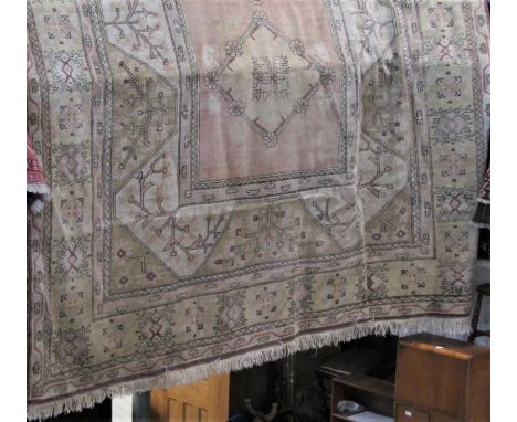 A good large Turkish caucasian carpet with typical pastel medallions upon a light ground 