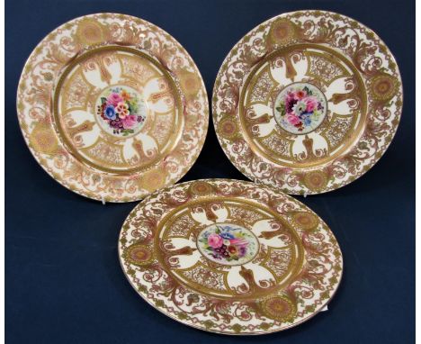 A set of three good quality Royal Worcester cabinet plates with central floral panels painted by E Philllips within ornate gi