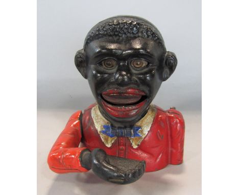 A vintage cast iron money box - Little Joe with original painted finish Mechanical cast iron banks were first manufactured in