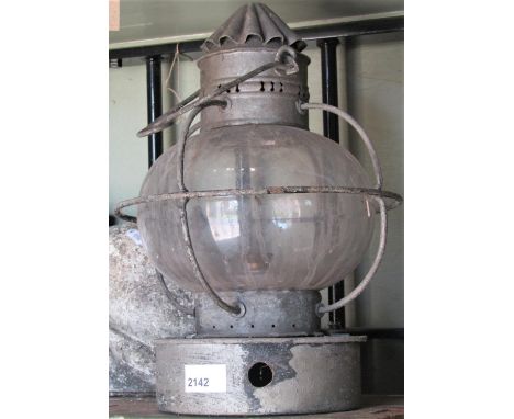 A vintage paraffin storm lantern, with globular glass encased shade 