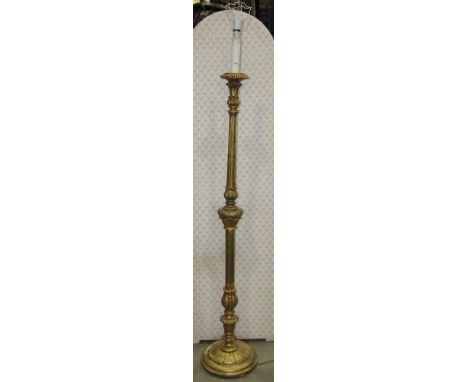 A carved and gilded lamp standard, fluted column raised on a disc base 