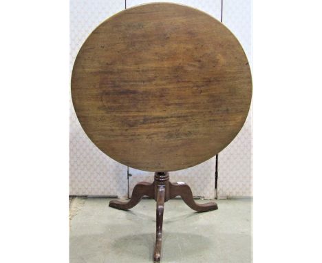 An early 19th century mahogany snap top occasional table of circular form raised on ring turned and tapered pillar and swept 