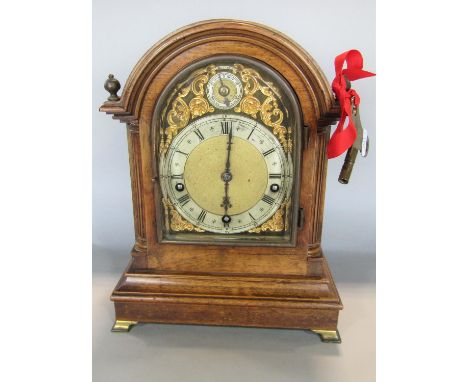 A 19th century walnut bracket clock enclosing a three train German movement with regulator, the arched dial with silvered cha