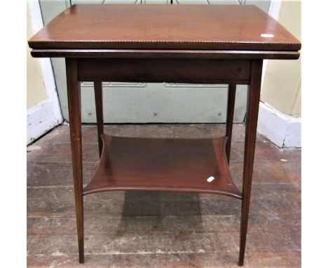 Small inlaid Edwardian mahogany fold over top card table raised on four square taper legs with under gallery 