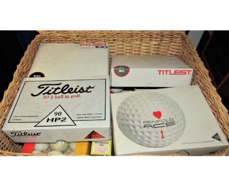 A small wicker basket enclosing a quantity of boxed unused golf balls including Penfold Ace One Titleist and Dunlop examples 