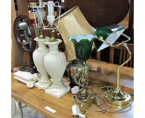 An early 20th century Pullman brass lamp with later glass shade, a contemporary bankers type table lamp, three further lamps 