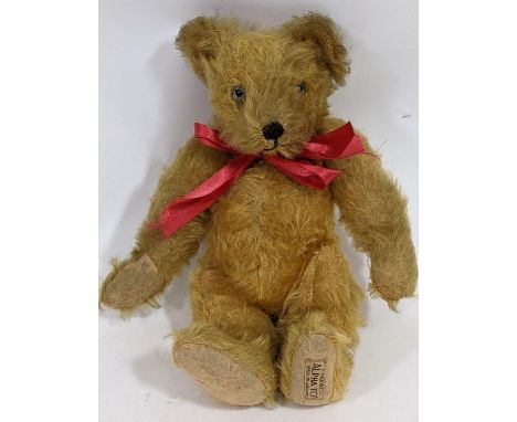 Small 1930's teddy bear 'A Farnell Alpha toy' with golden plush fur and jointed body, pronounced nose and humped back. Height