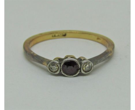 18ct ruby and diamond three stone ring, size L/M, 1.9g (one diamond needs resetting) 