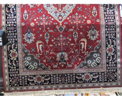 Belgian Nerahbad wall carpet decorated with floral decoration upon a red ground with navy blue ground running borders, 310 x 