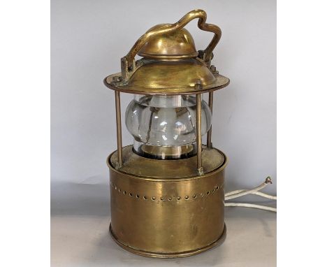 A good quality heavy brass marine lantern - circular, fitted with a clear glass lens and rising/fall shutter, stamped E G &am
