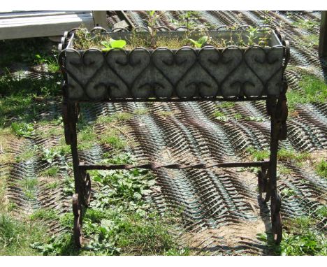 A flower trough/planter of rectangular form with removeable galvanized tin liner within an ironwork frame with S and C scroll