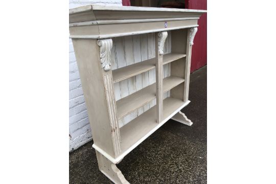 A Painted Wall Dresser With Moulded Cornice Above Open Shelves