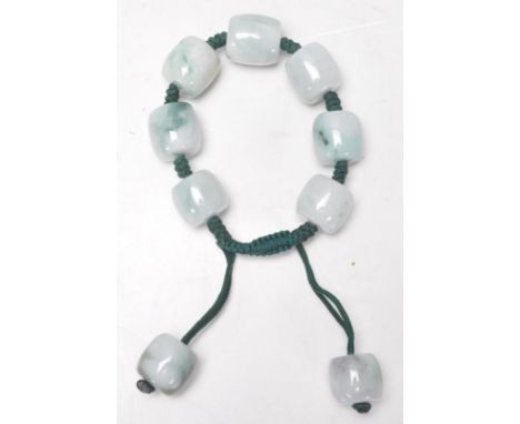 A vintage 20th Century Chinese green jade bangle bracelet having seven large round jade beads with two toggles. Strung togeth