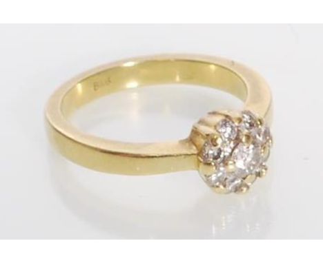 A stamped 18ct gold diamond cluster ring having a head set with nine round cut diamonds. Diamonds estimated at 39 pts. Weight