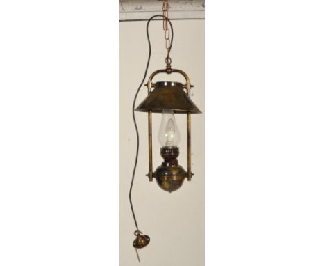 A contemporary antique style large brass hanging lantern of oil lamp type with modern electric wiring. The brass reservoir wi