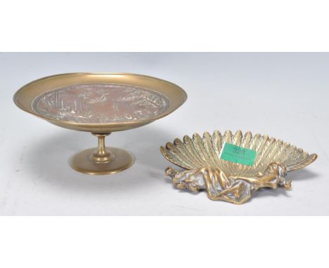 An early late 19th / 20th Century pin dish in the form of a recumbent female holding a large feathered fan, together with a s