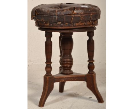 A Victorian 19th century mahogany and leather revolving piano stool. Raised on ring turned legs with central column having ov