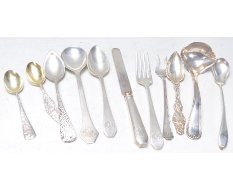 A collection of American silver flatware to include a Sterling stamped ladle, 1909 dated sterling knife, spoons and fork set 