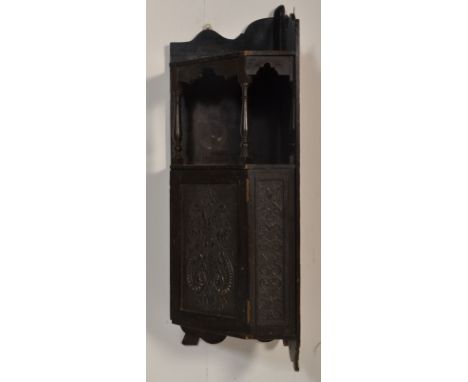 A 19th Century Victorian hanging corner cupboard having open shelf space above a cupboard below with carved scroll and floral