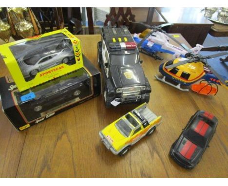 A selection of boxed and unboxed model cars and  vehicle and a helicopter to include a Maisto Special edition Jaguar XJ220 