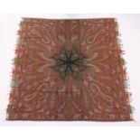 A KASHMIRI TEXTILE/SHAWL, woven in reds and greens, with a radiating design. 5ft 10ins x 5ft 8ins.