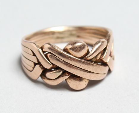 A 9CT ROSE GOLD PUZZLE RING..