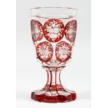 A GOOD BOHEMIAN GOBLET with eleven ruby panels of flowers. 6ins high.