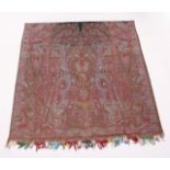 A GOOD LARGE KASHMIR TEXTILE, woven in reds and greens to a Paisley design. 11ft 4ins x 5ft 3ins.