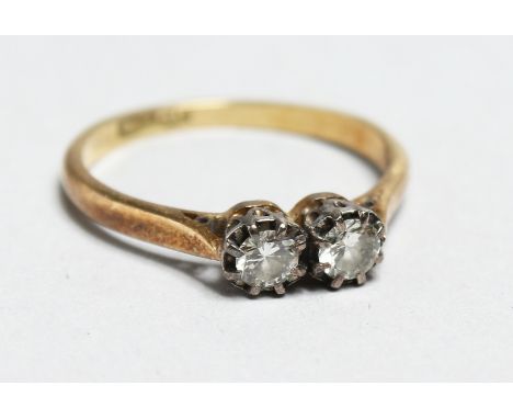 AN 18CT GOLD  TWO STONE DIAMOND RING.