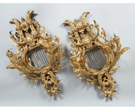 A GOOD PAIR OF  CLASSICAL REVIVAL ORMOLU FOUR LIGHT WALL APPLIQUES, of lyre form with eagle head crestings and mask decoratio