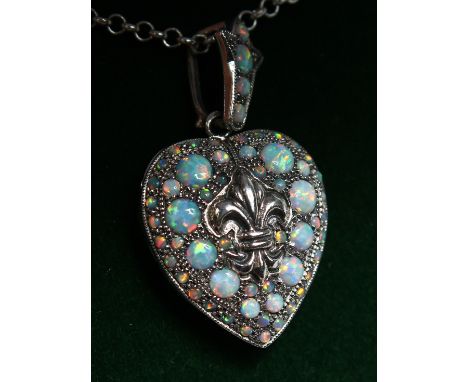 A SILVER AND OPAL HEART SHAPED LOCKET AND CHAIN.