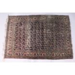 AN EARLY 20TH CENTURY PERSIAN RUG, dark blue ground with stylized Botek decoration (worn). 5ft